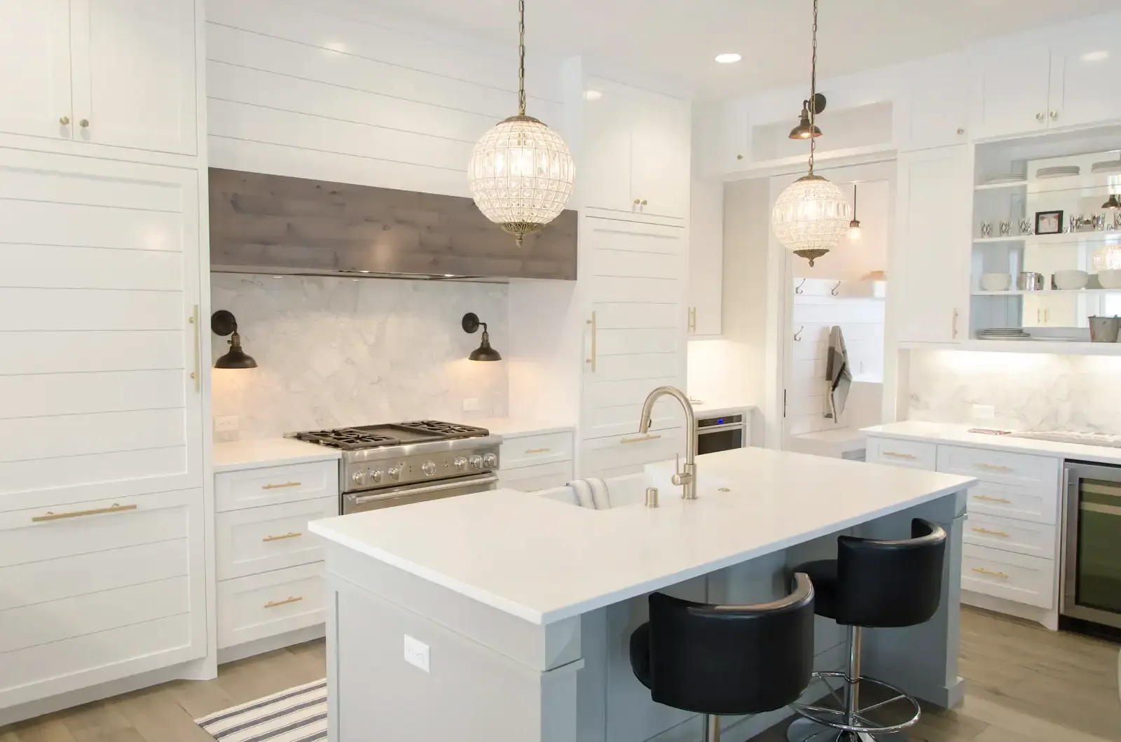 A white shaker kitchen with a marble backsplash and an island. Shown on the Full kitchen plan page for San Jose, CA.